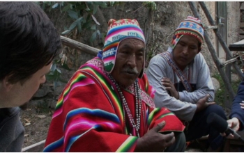 Photo shows indigenous Bolivian men being interviewed by linguists.